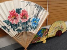 THREE ORNAMENTAL ORIENTAL-STYLE FURNISHING FANS including very large floral painted bamboo fan,