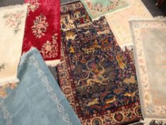 INDIAN WOOLEN RUG decorated with animals and figures, mainly blue ground, 152 x 224cms, together