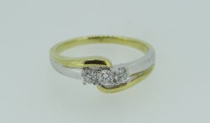 18K YELLOW & WHITE GOLD THREE STONE DIAMOND CROSS-OVER RING