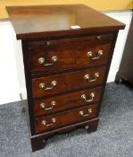 REPRODUCTION HARDWOOD SMALL CHEST having four drawers, brass handles, bracket feet and upper slide