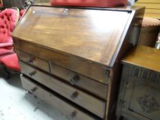 ANTIQUE MAHOGANY DROP-DOWN BUREAU with two short, two long drawer base