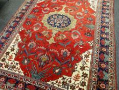 LARGE PERSIAN WOOLEN RUG, mainly red and blue ground and patterned, 350 x 253cms