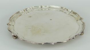 SILVER SALVER crimped rim, galleried border, raised over three scroll feet, Birmingham 1973, 13ozs