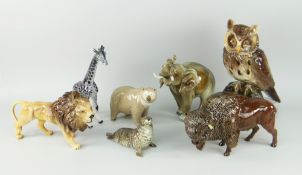 SEVEN ASSORTED CERAMIC WILD ANIMAL SCULPTURES including Beswick prowling lion, Beswick seal, owl,