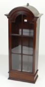 NEAT ANTIQUE-REPRODUCTION HANGING MAHOGANY CABINET, single sectional glazed door with dome top,