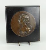 CIRCULAR BRONZE PORTRAIT PLAQUE mounted to an ebonized wooden hanging board, the bronze indistinctly
