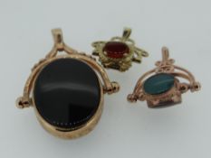 THREE 9CT GOLD REVOLVING FOBS SET WITH VARIOUS STONES, 15.8gms overall