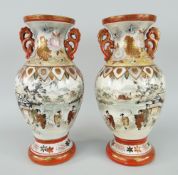 PAIR OF TWIN HANDLED KUTANI BALUSTER VASES with twin floral handles, decorated with wildlife and