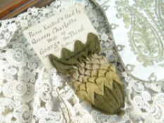 INTERESTING DISPLAY OF FABRIC ITEMS IN A HALF DOME DISPLAY CASE, possibly Royal Family related,