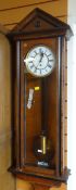 EDWARDIAN MAHOGANY & EBONIZED WALL CLOCK with circular dial and bearing Roman numerals