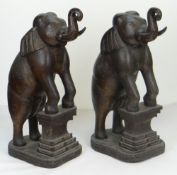 PAIR OF CARVED FLOOR STANDING INDIAN ELEPHANTS, both with trunk curled upwards and front hooves