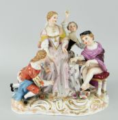CONTINENTAL PORCELAIN GROUP OF FOUR FIGURES on naturalistic scrolling base, 18cms high