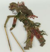 CHINESE BUFFALO HIDE DYED SHADOW PUPPET in the form of a figure in ornate costume, 33cms high