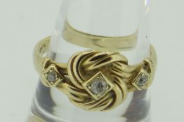 18CT YELLOW GOLD DIAMOND SET KNOT DESIGN RING, 4.9gms.