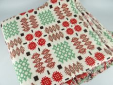 TRADITIONAL WELSH WOOL BLANKET, cream ground with multi-coloured geometric decoration and fringe,