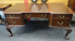 REPRODUCTION BREAK-FRONT DESK on ornate carved ball and claw supports and with bank of five drawers,