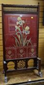 AESTHETIC-MOVEMENT FIRE SCREEN with carved bobbins and open work, the panel with floral upholstery