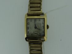 18CT YELLOW GOLD GENTS WRISTWATCH HAVING PLATED STRAP.