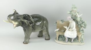 NAO MODEL OF A GIRL ON A BENCH FEEDING DOVES, together with a Melba ware pottery elephant model