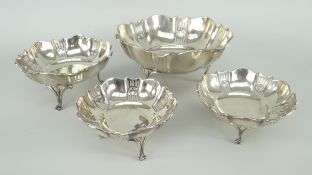 GRADUATED SET OF FOUR SILVER BON-BON DISHES each on three leaf-form feet with decorative open-work