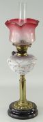 ANTIQUE BRASS & BLACK GLASS BASED OIL LAMP, floral vaseline glass reservoir, tinted cranberry and