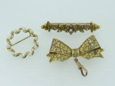 THREE BROOCHES comprising 9ct yellow gold vintage bow-brooch, antique seed-pearl set yellow metal