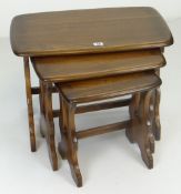 ERCOL NEST OF THREE COFFEE TABLES of rounded rectangular form, largest 57cms wide