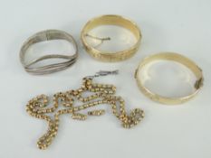 TWO GOLD PLATED SCROLL ENGRAVED BANGLES together with white metal bangle stamped 'Mexico 950',