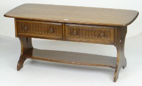ERCOL LONG JOHN COFFEE TABLE of rounded rectangular form, two fluted drawers with turned knobs and