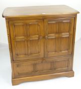 ERCOL TV CABINET with base drawer and carved panel design, 92cms wide