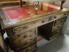 GOOD VINTAGE OAK DESK with arrangement of eight drawers, tooled leather top, 137cms wide x 80cms