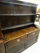 ANTIQUE PRIMITIVE DRESSER having a closed base with two cupboards and two drawers, two shelf boarded