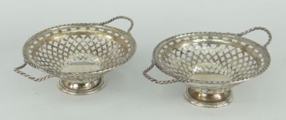 PAIR OF DELICATE SILVER TWIN-HANDLED BASKETS with twist handles to twist rim, pierced bodies,