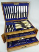 VINTAGE OAK CANTEEN OF BONE HANDLE MONOGRAMMED CUTLERY, two base drawers and hinged lid, seemingly
