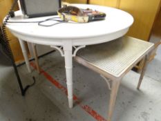 WHITE PAINTED CIRCULAR EXTENDING TABLE on bamboo type supports, together with similar cane work sudo