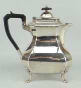 SILVER COFFEE-POT of faceted form on four claw feet, ebonised handle and knop, Sheffield 1926, 21ozs