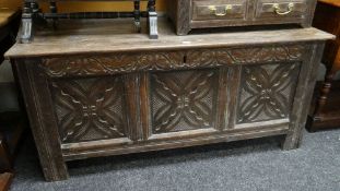 19TH CENTURY CARVED OAK BLANKET CHEST having three floret carved panels and carves frieze, 132cms