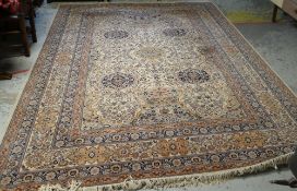LARGE MAINLY FAWN & BLUE MULTI-PATTERNED PERSIAN RUG with large centre cartouche decoration and