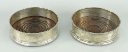 PAIR OF ELIZABETH II SILVER & WOOD WINE-COASTERS with beaded rims, London 1972, 13cms diam