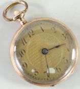 SMALL 9CT YELLOW GOLD PENDANT WATCH having a yellow metal dial bearing Arabic numerals, monogram