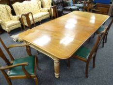 VICTORIAN MAHOGANY EXTENDING DINING TABLE on reeded and turned supports with casters, to accommodate