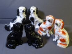 THREE PAIRS OF STAFFORDSHIRE SEATED SPANIELS