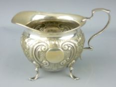 SILVER CREAM JUG - bowl shaped body on four shell supports with scrolled handle and scrolled and