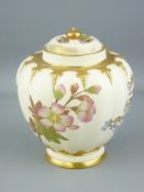 ROYAL WORCESTER - a globular floral decorated blush bowl on a shallow gilt rimmed pedestal with