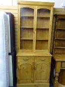 REPRODUCTION LIGHT-WOOD BOOKCASE CUPBOARD, twin upper-glaze doors over two frieze drawers and