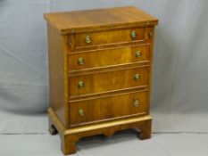REPRODUCTION MAHOGANY BACHELOR'S TYPE CHEST of four drawers with fold-over top on corner bracket