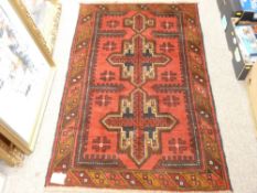 BALUCHI RUG, red ground single bordered with gothic type central pattern, 137 x 87cms