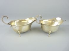 PAIR OF ASPREY SILVER CREAM OR SAUCE BOATS - each on three pad feet with plain bodies, London