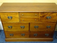 REPRODUCTION MAHOGANY SIDEBOARD CHEST of eight various drawers on a plinth base, 85cms height,