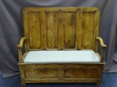 CIRCA 1820 BOX SEAT PINE SETTLE with swept arms and four panel back, 133cms height, 144cms width,